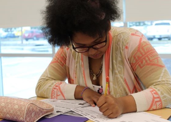 Student working on an assignment at her desk