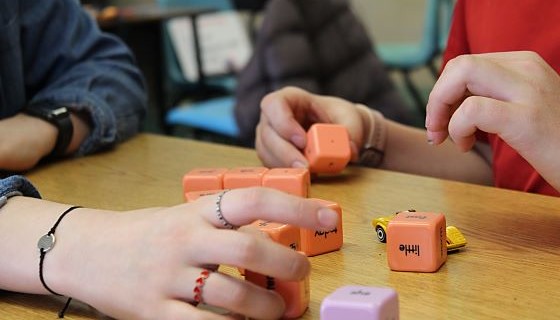 Teacher and student playing with blocks