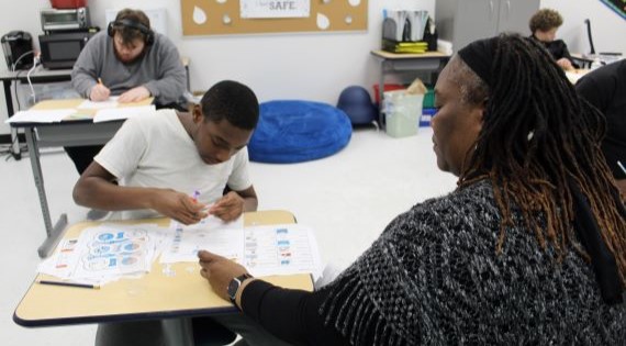 Student and teacher working on an activity together