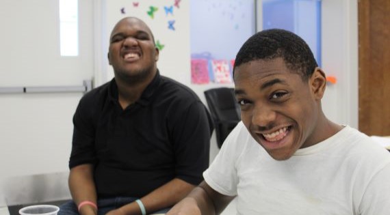 Two students laughing in their classroom