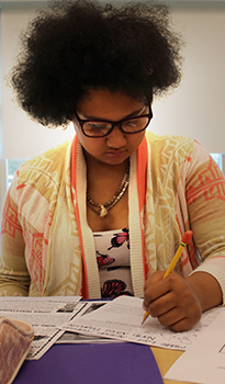 Student Writing at her Desk
